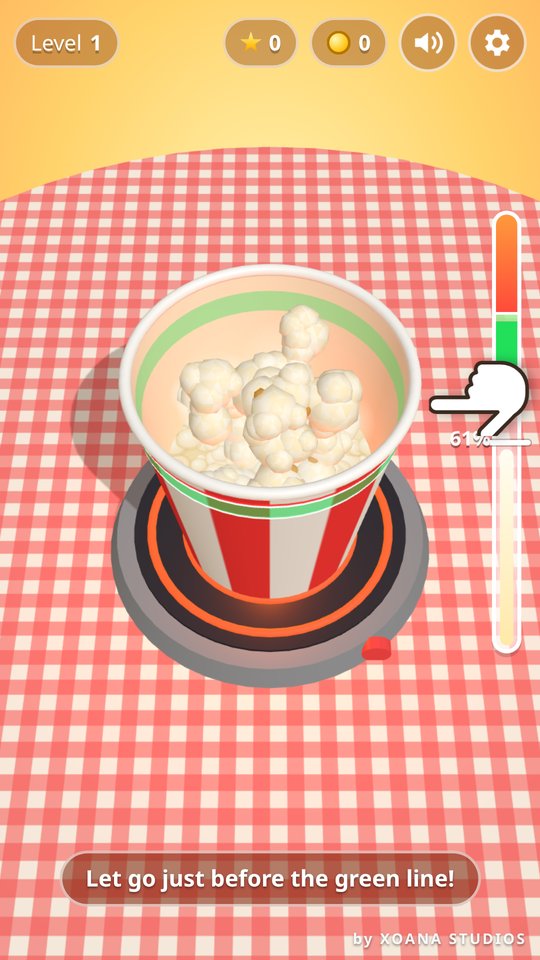 Popcorn Popper tutorial hand pointing at the green line as popcorn fills the striped bucket